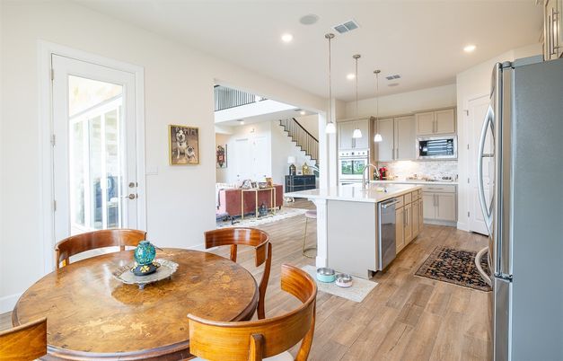 Dining room, Interior, Kitchen, Pendant Lights, Recessed Lighting, Stainless Steel Appliances, Wood Texture Flooring