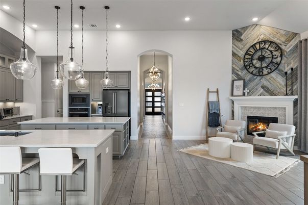 Fireplace, Interior, Kitchen, Living room, Pendant Lights, Recessed Lighting, Stainless Steel Appliances, Stone Walls, Wood Texture Flooring