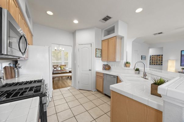Chandelier, Dining room, Interior, Kitchen, Recessed Lighting, Tile Countertops, Wood Texture Flooring
