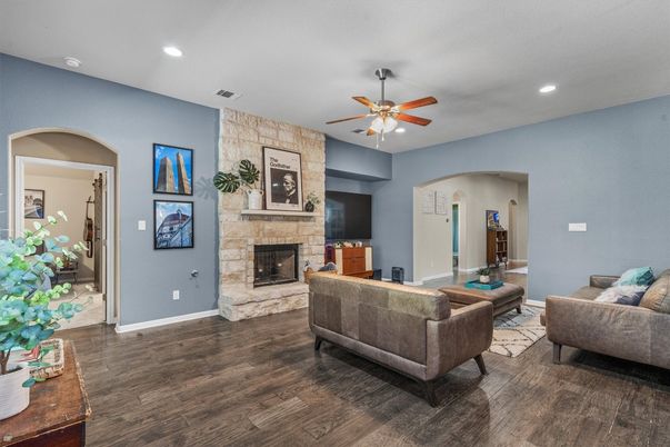 Fireplace, Interior, Living room, Recessed Lighting, Stone Walls, Wood Texture Flooring