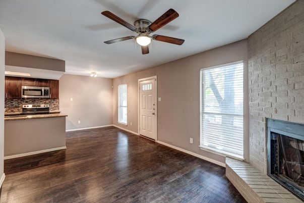 Empty room, Fireplace, Interior, Kitchen, Stainless Steel Appliances, Stone Walls, Wood Texture Flooring