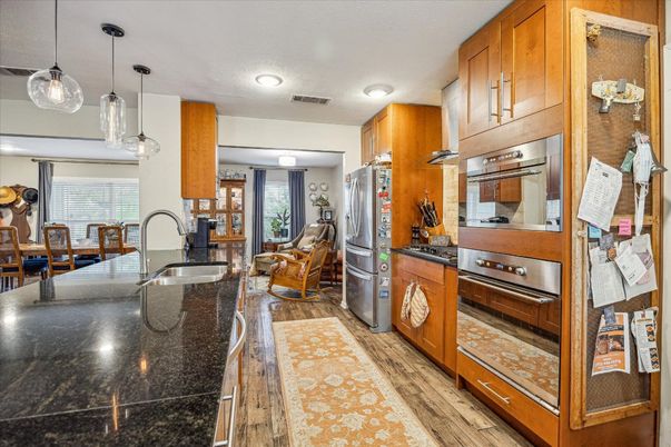 Dining room, Interior, Kitchen, Pendant Lights, Recessed Lighting, Stainless Steel Appliances, Wood Texture Flooring