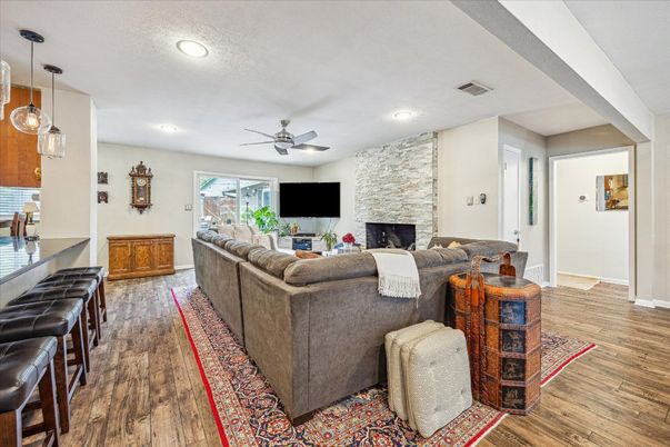 Fireplace, Interior, Living room, Pendant Lights, Recessed Lighting, Stone Walls, Wood Texture Flooring