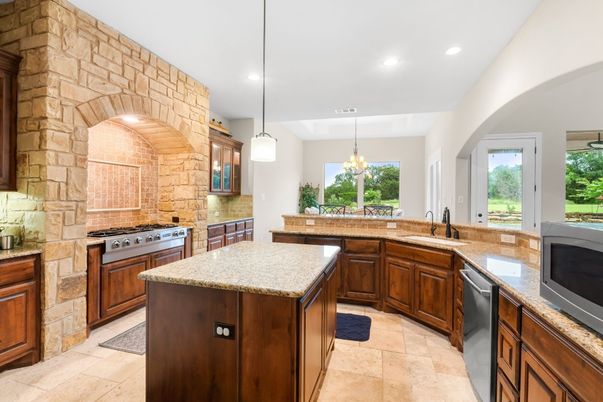Chandelier, Interior, Kitchen, Pendant Lights, Recessed Lighting, Stainless Steel Appliances, Stone Walls