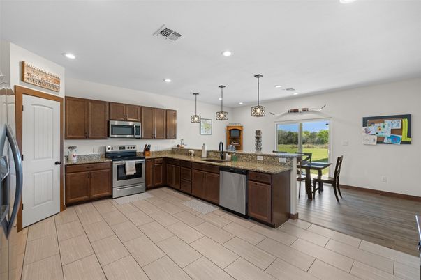 Dining room, Interior, Kitchen, Pendant Lights, Recessed Lighting, Stainless Steel Appliances, Wood Texture Flooring