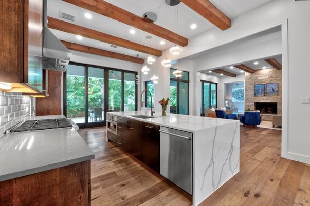 Fireplace, Interior, Kitchen, Living room, Pendant Lights, Recessed Lighting, Stainless Steel Appliances, Stone Walls, Wooden Beams, Wood Texture Flooring