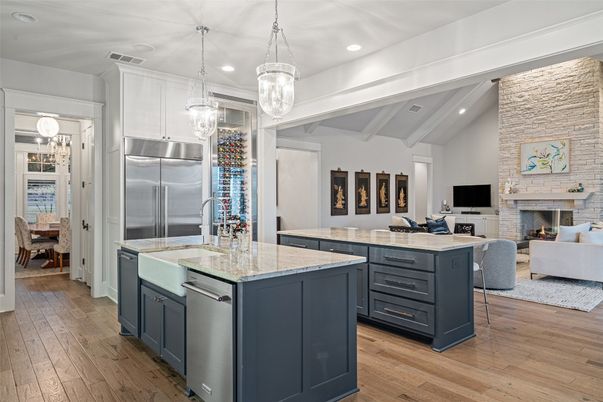 Fireplace, Interior, Kitchen, Living room, Pendant Lights, Recessed Lighting, Stainless Steel Appliances, Stone Walls, Wood Texture Flooring