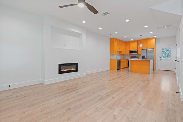 Empty room, Fireplace, Interior, Kitchen, Pendant Lights, Recessed Lighting, Wood Texture Flooring