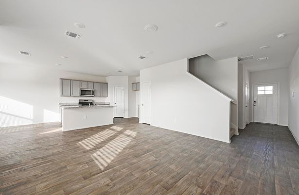 Empty room, Interior, Kitchen, Recessed Lighting, Stainless Steel Appliances, Wood Texture Flooring