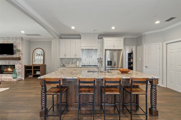 Fireplace, Interior, Kitchen, Recessed Lighting, Stainless Steel Appliances, Stone Walls, Wood Texture Flooring