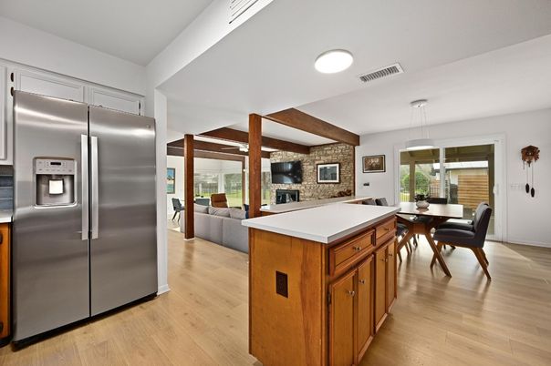 Dining room, Fireplace, Interior, Kitchen, Living room, Pendant Lights, Stainless Steel Appliances, Stone Walls, Wood Texture Flooring