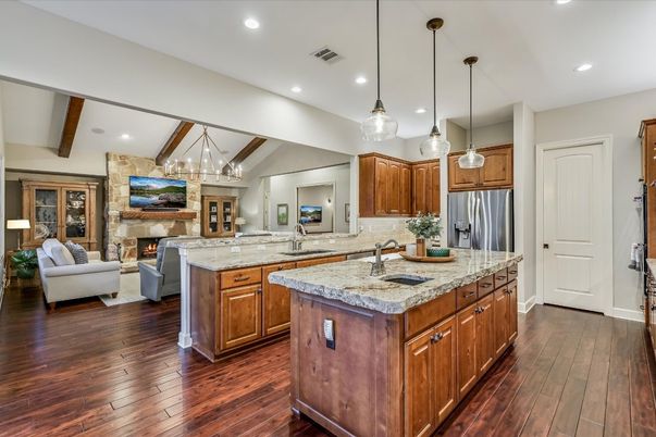 Chandelier, Fireplace, Interior, Kitchen, Living room, Pendant Lights, Recessed Lighting, Stainless Steel Appliances, Stone Walls, Wooden Beams, Wood Texture Flooring