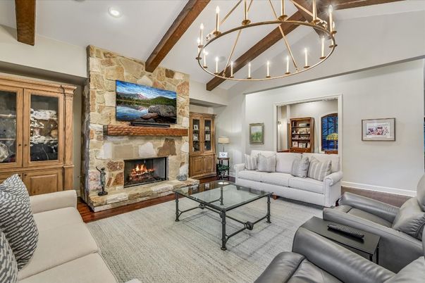 Chandelier, Fireplace, Interior, Living room, Recessed Lighting, Stone Walls, Wooden Beams, Wood Texture Flooring