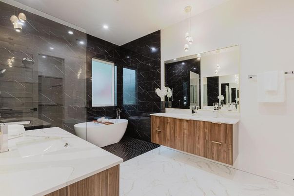 Bathroom, Dual Sink Vanities, Glass Shower, Interior, Marble, Marble Walls, Pendant Lights, Recessed Lighting