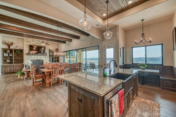 Chandelier, Dining room, Fireplace, Interior, Kitchen, Living room, Pendant Lights, Recessed Lighting, Stone Walls, Water, Wooden Beams, Wooden Ceilings, Wood Texture Flooring