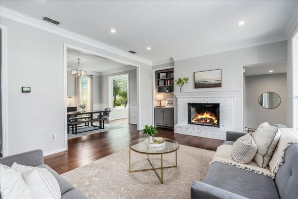 Chandelier, Dining room, Fireplace, Interior, Living room, Pendant Lights, Recessed Lighting, Wood Texture Flooring
