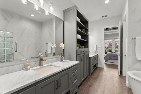 Bathroom, Dual Sink Vanities, Interior, Marble Walls, Recessed Lighting, Wood Texture Flooring