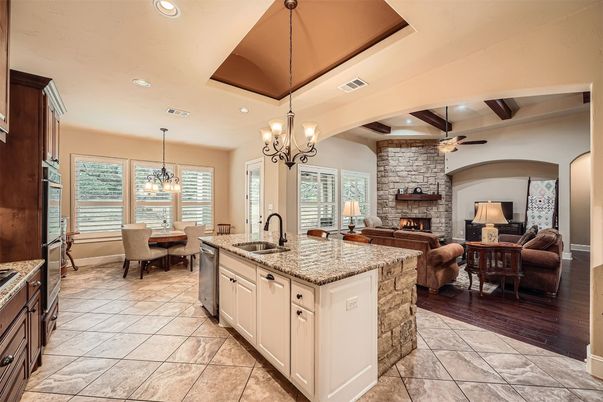 Chandelier, Dining room, Fireplace, Interior, Kitchen, Living room, Pendant Lights, Recessed Lighting, Stone Walls, Wooden Beams, Wood Texture Flooring