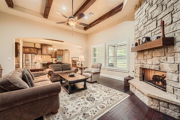 Chandelier, Fireplace, Interior, Kitchen, Living room, Recessed Lighting, Stainless Steel Appliances, Stone Walls, Wood Texture Flooring