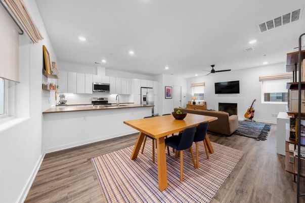 Dining room, Fireplace, Interior, Kitchen, Living room, Recessed Lighting, Stainless Steel Appliances, Wood Texture Flooring