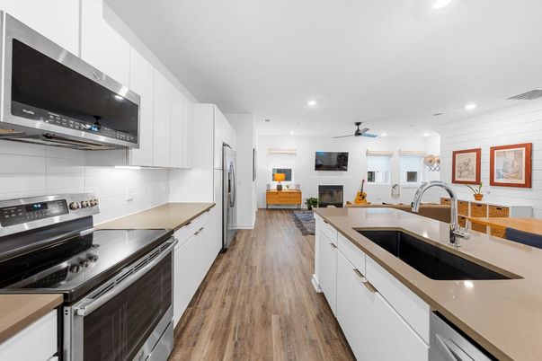 Fireplace, Interior, Kitchen, Recessed Lighting, Stainless Steel Appliances, Wood Texture Flooring