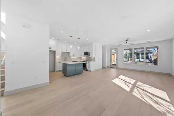Empty room, Interior, Kitchen, Pendant Lights, Recessed Lighting, Stainless Steel Appliances, Wood Texture Flooring