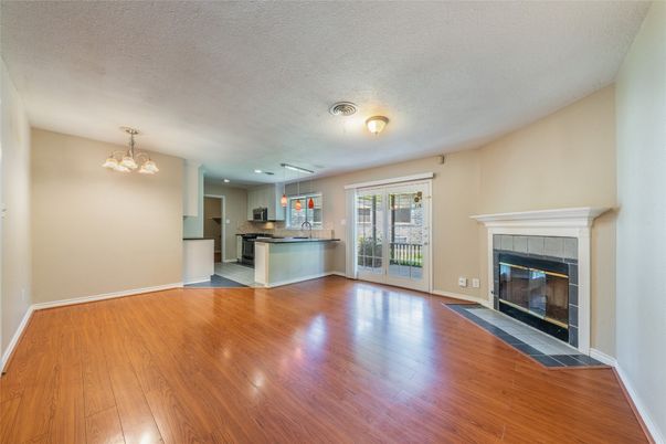 Empty room, Fireplace, Interior, Kitchen, Pendant Lights, Recessed Lighting, Wood Texture Flooring