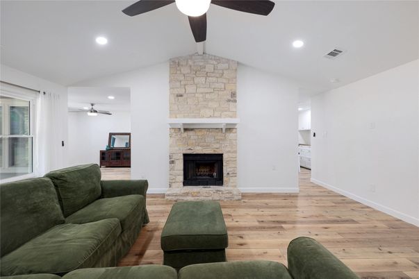 Fireplace, Interior, Living room, Recessed Lighting, Stone Walls, Wood Texture Flooring