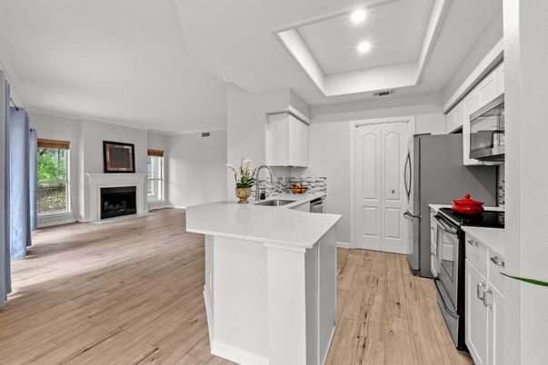 Fireplace, Interior, Kitchen, Recessed Lighting, Stainless Steel Appliances, Wood Texture Flooring