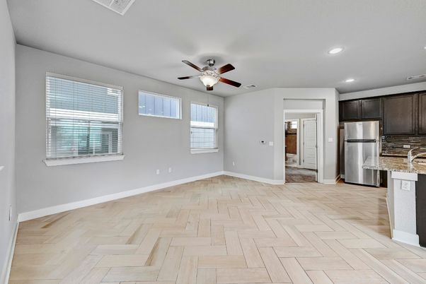 Empty room, Interior, Kitchen, Recessed Lighting, Stainless Steel Appliances, Wood Texture Flooring