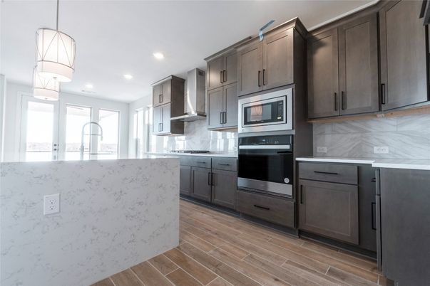 Interior, Kitchen, Marble Walls, Pendant Lights, Recessed Lighting, Stainless Steel Appliances, Wood Texture Flooring