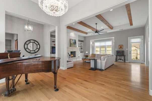 Chandelier, Fireplace, Interior, Living room, Piano, Recessed Lighting, Wooden Beams, Wood Texture Flooring