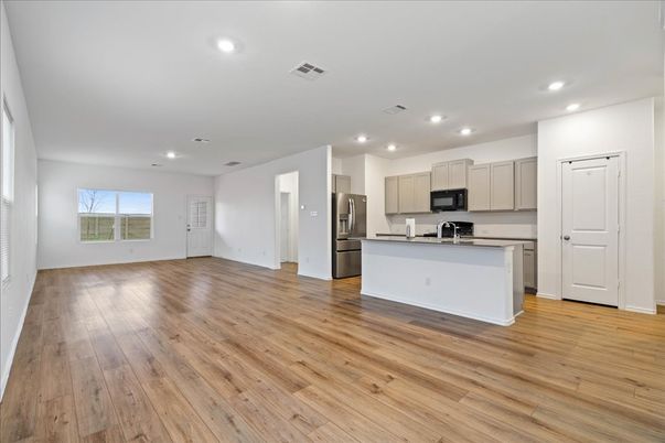 Empty room, Interior, Kitchen, Recessed Lighting, Stainless Steel Appliances, Wood Texture Flooring
