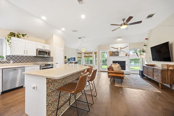 Fireplace, Interior, Kitchen, Living room, Pendant Lights, Recessed Lighting, Stainless Steel Appliances, Wood Texture Flooring