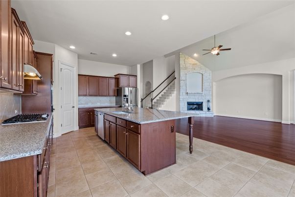 Fireplace, Interior, Kitchen, Recessed Lighting, Stone Walls, Wood Texture Flooring