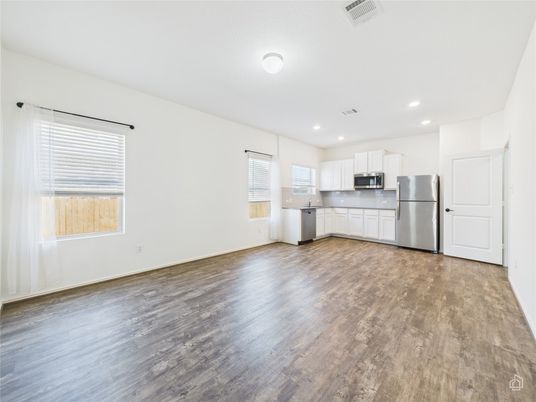 Empty room, Interior, Kitchen, Recessed Lighting, Stainless Steel Appliances, Wood Texture Flooring