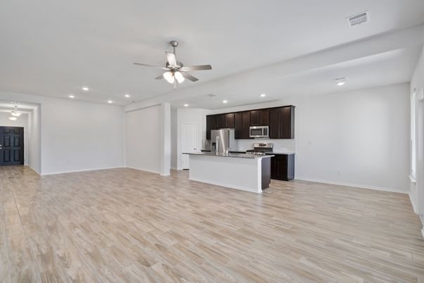 Empty room, Interior, Kitchen, Recessed Lighting, Stainless Steel Appliances, Wood Texture Flooring