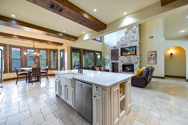 Chandelier, Dining room, Fireplace, Interior, Kitchen, Living room, Recessed Lighting, Stainless Steel Appliances, Stone Walls, Wooden Beams
