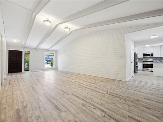 Empty room, Interior, Kitchen, Recessed Lighting, Stainless Steel Appliances, Wood Texture Flooring