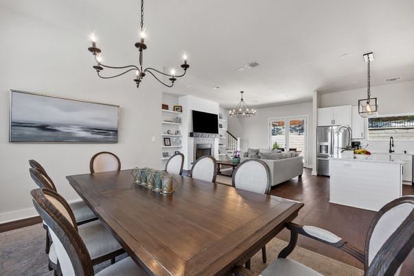 Chandelier, Dining room, Fireplace, Interior, Kitchen, Living room, Pendant Lights, Recessed Lighting, Stainless Steel Appliances, Wood Texture Flooring