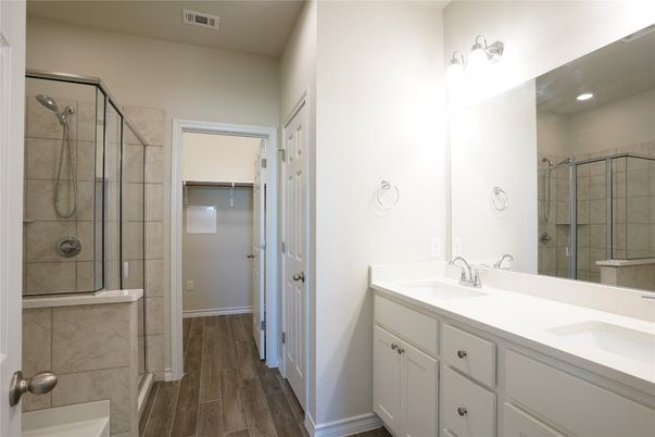 Bathroom, Dual Sink Vanities, Glass Shower, Interior, Recessed Lighting, Wood Texture Flooring