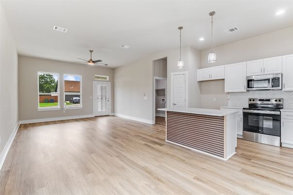 Empty room, Interior, Kitchen, Pendant Lights, Recessed Lighting, Stainless Steel Appliances, Wood Texture Flooring