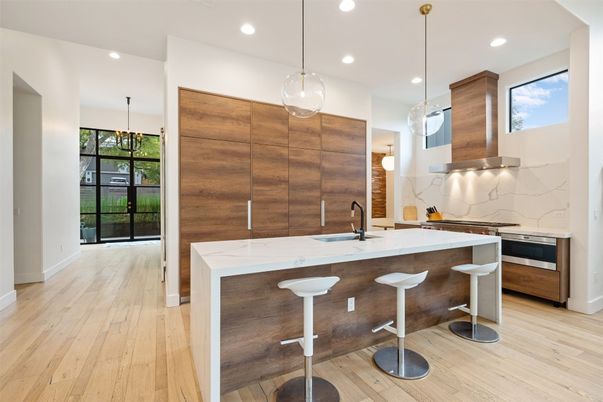 Interior, Kitchen, Marble Walls, Pendant Lights, Recessed Lighting, Stainless Steel Appliances, Wood Texture Flooring