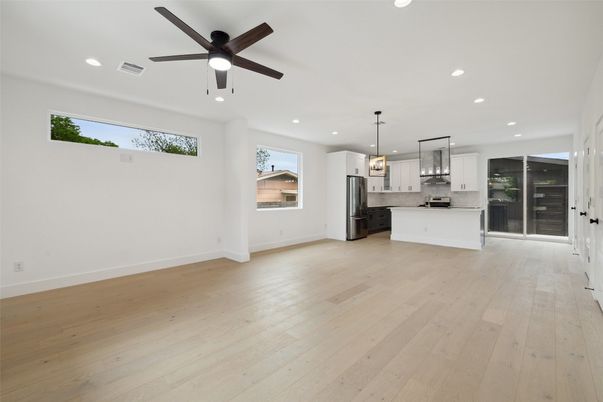 Empty room, Interior, Kitchen, Pendant Lights, Recessed Lighting, Stainless Steel Appliances, Wood Texture Flooring
