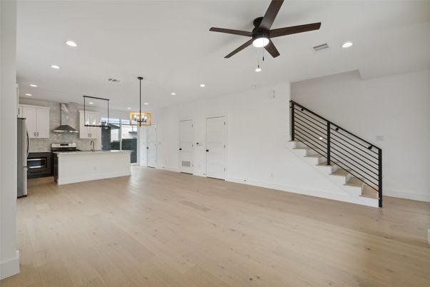 Chandelier, Empty room, Interior, Kitchen, Pendant Lights, Recessed Lighting, Stainless Steel Appliances, Wood Texture Flooring