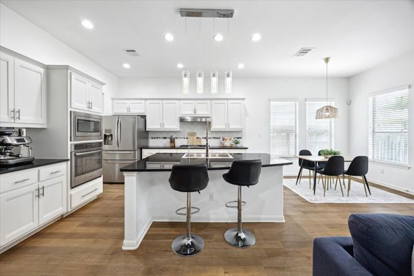 Dining room, Interior, Kitchen, Pendant Lights, Recessed Lighting, Stainless Steel Appliances, Wood Texture Flooring