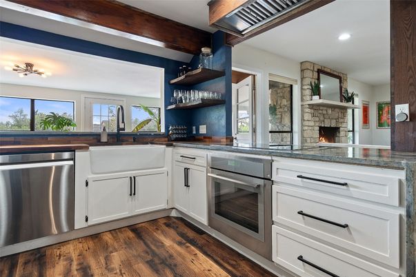 Fireplace, Interior, Kitchen, Recessed Lighting, Stainless Steel Appliances, Stone Walls, Wood Texture Flooring