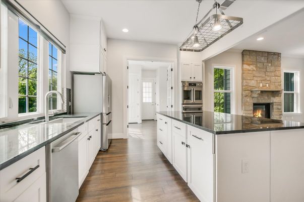 Fireplace, Interior, Kitchen, Pendant Lights, Recessed Lighting, Stainless Steel Appliances, Stone Walls, Wood Texture Flooring
