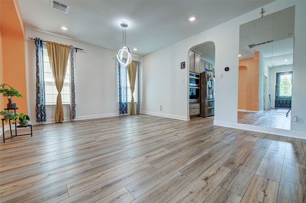 Empty room, Interior, Kitchen, Pendant Lights, Recessed Lighting, Stainless Steel Appliances, Wood Texture Flooring
