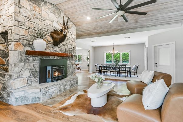 Chandelier, Dining room, Fireplace, Interior, Living room, Recessed Lighting, Stone Walls, Wooden Ceilings, Wood Texture Flooring